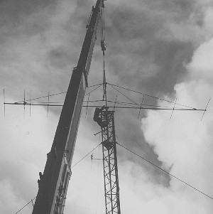 Rod, ZL3NW securing the yagi to the tower.  The crane used was 50 tonne working load and weighed 43 tonnes itself.  It was 'on hand' at the right price!  The only problem was getting it out from below the tower - it got stuck in the mud!