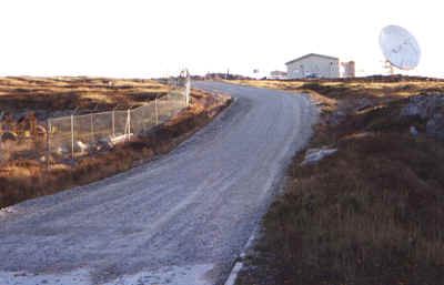 The main road out of Stanley for Mount Pleasant airport and Goose Green. The dish in the background is the C&W earth station and note the deep pothole in the foreground!