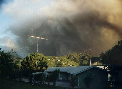 An early evening ash eruption seen from the VP2MDD QTH, with the six-metre yagi and Windom support mast in the foreground.