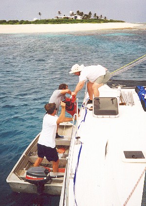 Unloading gear from the cat moored 200m out from the shore.