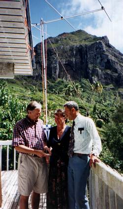 OH2BR presenting the SRAL pennant to his hosts Tom, VP6TC and Betty, VP6YL on their balcony, following his successful operation as VP6BR. The photo also shows the six-metre yagi in its new location, with Fletcher Christians Cave in the background.